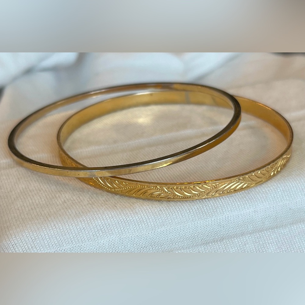 2 Vintage gold tone bangle bracelets one of which is etched